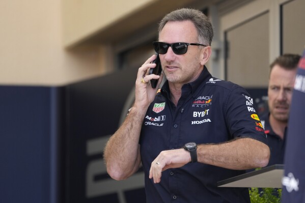 Red Bull team principal Christian Horner speaks on a mobile phone prior to the first practice session ahead of the Formula One Bahrain Grand Prix at the Bahrain International Circuit in Sakhir, Bahrain, Thursday, Feb. 29, 2024. (AP Photo/Darko Bandic)