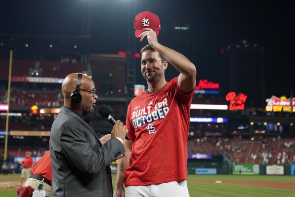 St. Louis Cardinals starting pitcher Adam Wainwright tips his cap while being interviewed after the Cardinals defeated the Milwaukee Brewers in a baseball game to clinch a playoff spot Tuesday, Sept. 28, 2021, in St. Louis. (AP Photo/Jeff Roberson)