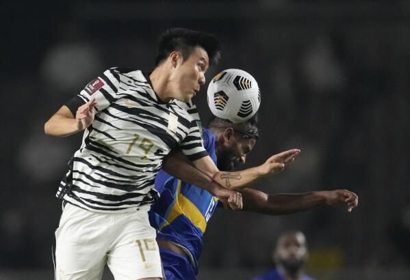 South Korea's Kim Young-gwon, left, fights for the ball against Sri Lanka's Ahmed Waseem during their Asian zone Group H qualifying soccer match for the FIFA World Cup Qatar 2022 at Goyang stadium in Goyang, South Korea, Wednesday, June 9, 2021. (AP Photo/Lee Jin-man)