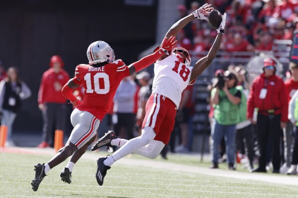 Nebraska receiver Isaiah Neyor, right, tries to catch a pass over Ohio State defensive back Denzel Burke during the first half of an NCAA college football game Saturday, Oct. 26, 2024, in Columbus, Ohio. (AP Photo/Jay LaPrete)