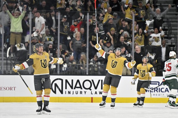 Vegas Golden Knights center Jack Eichel, left, and Tomas Hertl (48) celebrate after Eichel scored against the Minnesota Wild during the first period of an NHL hockey game Friday, April 12, 2024, in Las Vegas. (AP Photo/David Becker)
