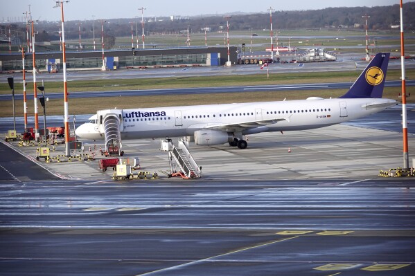 A Lufthansa aircraft stands on the apron at Hamburg Airport, Wednesday, Feb. 7, 2024. Ground staff for Lufthansa walked off the job at five major German airports on Wednesday, causing the airline to cancel hundreds of flights. The Ver.di union called on ground staff at Frankfurt and Munich, Lufthansa's two main hubs, as well as Berlin, Duesseldorf and Hamburg, to strike for 27 hours starting at 4 a.m. Wednesday.(Rabea Gruber/dpa via AP)