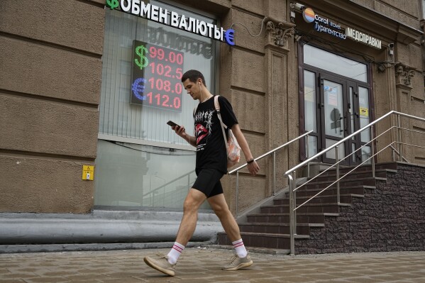 A man walks past a currency exchange office in Moscow, Russia, Monday, Aug. 14, 2023. Russia’s central bank made a big interest rate hike of 3.5 percentage points on Tuesday, Aug. 15, 2023, an emergency move designed to fight inflation and strengthen the ruble after the country's currency reached its lowest value since early in the war with Ukraine. (AP Photo/Alexander Zemlianichenko)