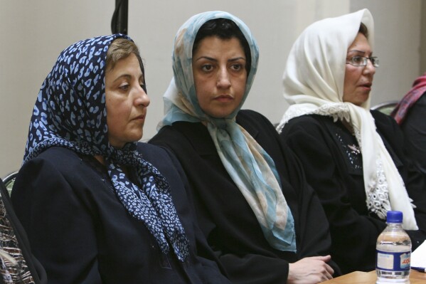 FILE - Prominent Iranian human rights activist Narges Mohammadi, center, sits next to Iranian Nobel Peace Prize laureate Shirin Ebadi, left, while attending a meeting on women's rights in Tehran, Iran, on Aug. 27, 2007. The Nobel Peace Prize has been awarded to Narges Mohammadi for fighting oppression of women in Iran. The chair of the Norwegian Nobel Committee announced the prize Friday, Oct. 6, 2023 in Oslo. (AP Photo/Vahid Salemi, File)