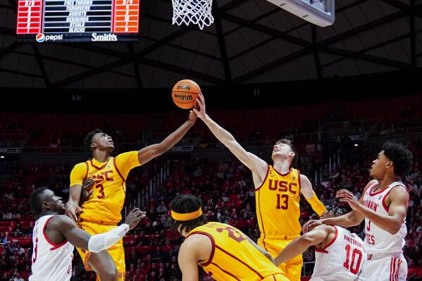 Southern California forward VIncent Iwuchukwu (3) and Southern California guard Drew Peterson (13) go for the ball while playing Utah during the first half of an NCAA college basketball game Saturday, Feb. 25, 2023, in Salt Lake City. (AP Photo/Ben B. Braun)