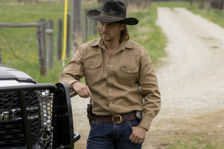 This image released by Paramount Network shows Luke Grimes in a scene from "Yellowstone." Grimes, best-known for his portrayal of the complex cowboy character Kayce Dutton on the hit show “Yellowstone,” will release his self-titled debut album on Friday. (Paramount Network via AP)