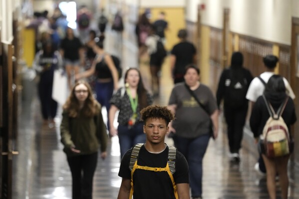 Students mix in a hallway as they change classes at Topeka High School Friday, May 10, 2024, in Topeka, Kan. Schools in the city were at the center of a case that struck down segregated education. Only the district's grade schools were segregated at the time of the ruling. (AP Photo/Charlie Riedel)