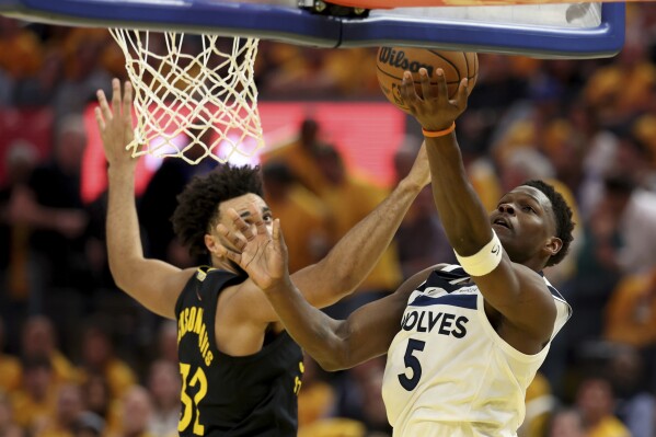 Minnesota Timberwolves guard Anthony Edwards (5) shoots against Golden State Warriors forward Trayce Jackson-Davis (32) during the first half of Game 4 in the Western Conference semifinals of the NBA basketball playoffs Monday, May 12, 2025, in San Francisco. (AP Photo/Jed Jacobsohn)