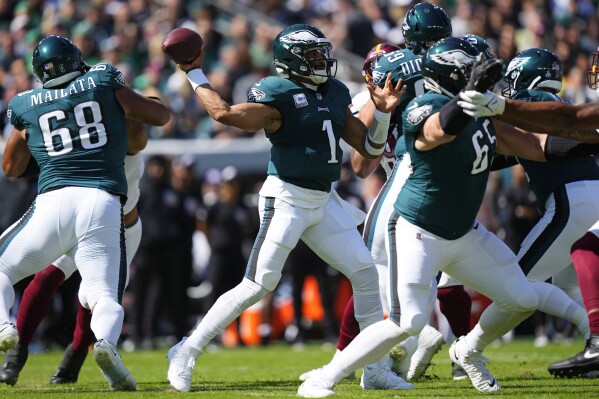 Philadelphia Eagles quarterback Jalen Hurts (1) looks to throw during the first half of an NFL football game against the Washington Commanders on Sunday, Oct. 1, 2023, in Philadelphia. (AP Photo/Matt Rourke)