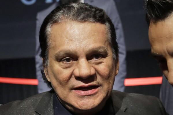 FILE - Boxing great Roberto Duran attends a news conference in New York, on Jan. 14, 2015. The family of boxing great Roberto Duran says he is receiving medical care for a heart problem. The 72-year-old Panamanian was a champion in four different weight classes. His family says he “has suffered a health complication due to an atrioventricular blockade." WBC president Mauricio Sulaiman says in a social media post that Duran is being treated in a hospital in Panama. (AP Photo/Seth Wenig)