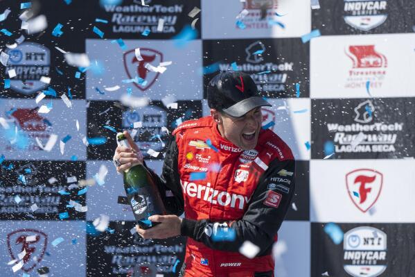 Team Penske driver Will Power, of Australia, celebrates after winning third place in the IndyCar season finale auto race at Laguna Seca Raceway on Sunday, Sept. 11, 2022, Monterey, Calif. Power also won the 2022 championship.(AP Photo/Nic Coury)