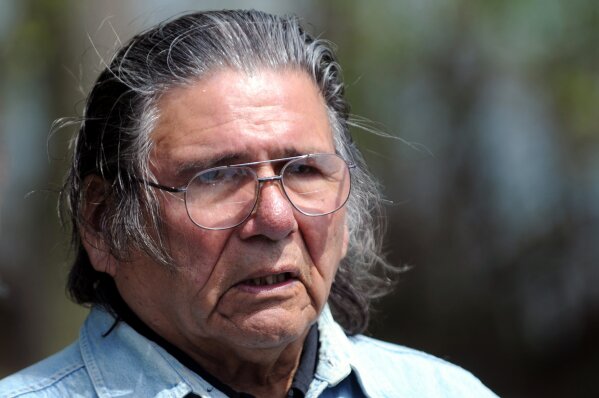
              In a Friday, May 14, 2010 photo, American Indian activist Dennis Banks waits to board a canoe to spread a net on Lake Bemidji near Bemidji, Minn., during an American Indian treaty rights protest. Banks, a co-founder of the American Indian Movement and a leader of the 1973 Wounded Knee occupation, died Sunday night at the Mayo Clinic in Rocheste., his family announced Monday, Oct. 30, 2017. He was 80. (Chris Polydoroff)/Pioneer Press via AP)
            