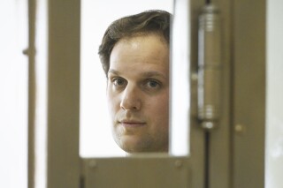 Wall Street Journal reporter Evan Gershkovich stands in a glass cage in a courtroom at the Moscow City Court in Moscow, Russia, Thursday, June 22, 2023. Gershkovich, a reporter detained on espionage charges in Russia, appeared in court Thursday to appeal his extended detention. (AP Photo/Dmitry Serebryakov)