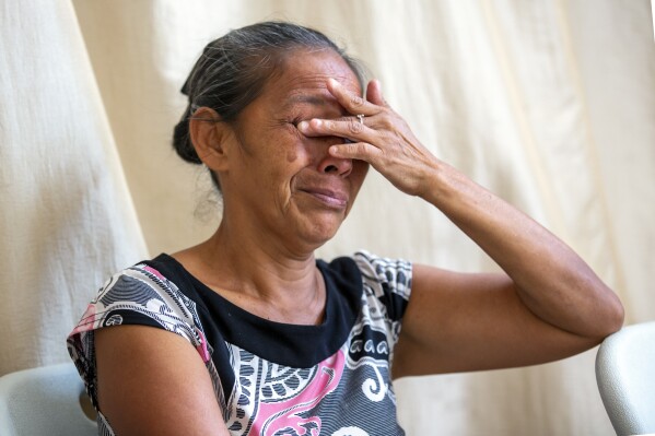 Guatemalan migrant Gloria Lobos cries while speaking about violence she and her family experienced, during an interview at a church-run shelter in Ciudad Juarez, Mexico, on Friday, Aug. 9, 2024. (AP Photo/Andres Leighton)
