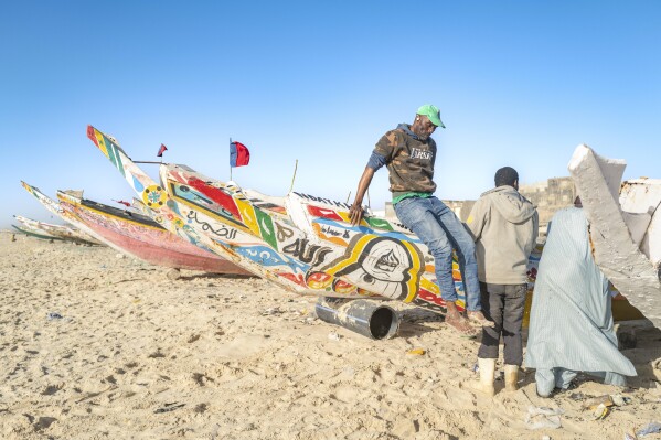Fishermen park their pirogues after returning from fishing in Saint-Louis, Senegal, Thursday, March 13, 2025. (AP Photo/Sylvain Cherkaoui)