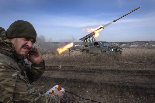 A Ukrainian officer from The 56th Separate Motorized Infantry Mariupol Brigade fires a multiple launch rocket system based on a pickup truck towards Russian positions at the front line, near Bakhmut, Donetsk region, Ukraine, Tuesday, March 5, 2024. (AP Photo/Efrem Lukatsky)