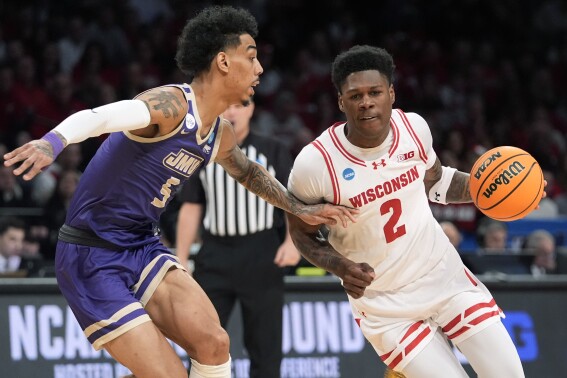Wisconsin guard AJ Storr (2) drives against James Madison guard Terrence Edwards Jr. (5) during the first half of a first-round college basketball game in the men's NCAA Tournament, Friday, March 22, 2024, in New York. (AP Photo/Mary Altaffer)