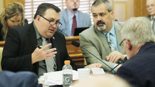 Kansas state Sen. Rob Olson, left, R-Olathe, speaks during negotiations between the House and Senate on legislation, Friday, April 28, 2023, at the Statehouse in Topeka, Kan. No big tax cuts are coming for Kansas residents even though the state treasury is bulging with surplus cash. (AP Photo/John Hanna)