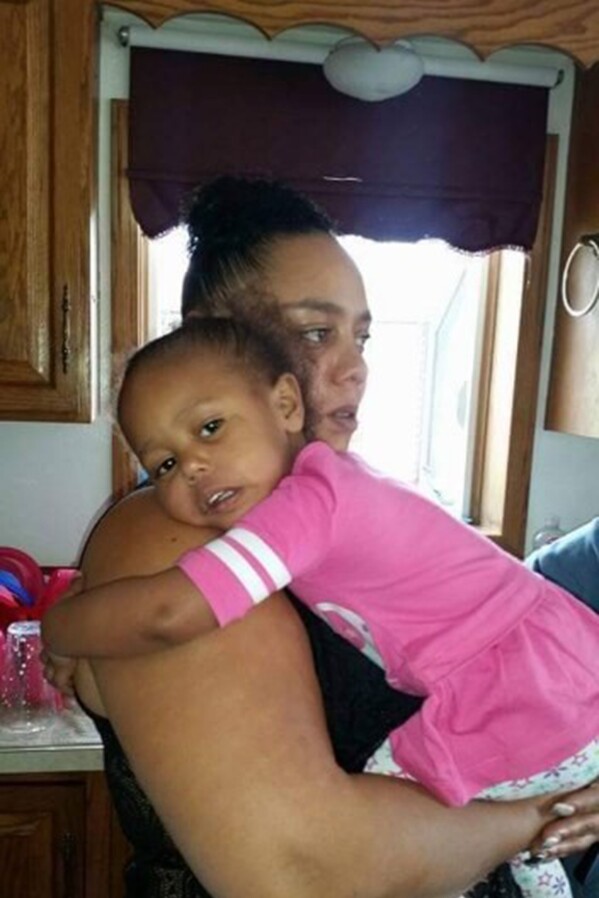 This photo provided Anthony LaCour shows his wife, Jerica LaCour, of Colorado Springs, Colo., holding one of their five children. She was stressed about family finances, Anthony recalled, when deputies found her distraught and trespassing at a trucking company in Jan. 11, 2018. (Anthony LaCour via AP)