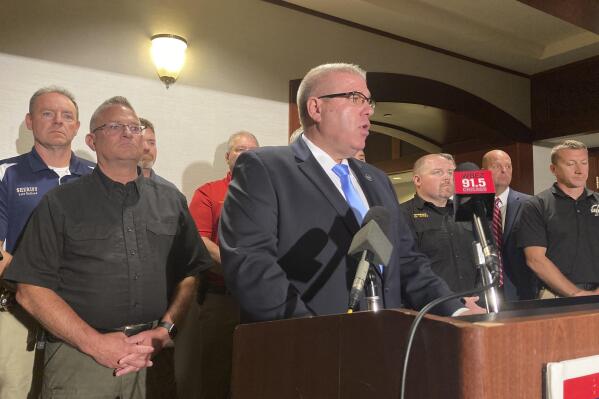 Illinois state Sen. Darren Bailey, the Republican nominee for governor, center, is joined by county sheriffs on Tuesday, Sept. 6, 2022. Bailey promised to restore the death penalty and repeal a wide-ranging criminal justice overhaul that will eliminate cash bail, following a Labor Day weekend that left multiple people dead in Chicago.  (AP Photo/John O’Connor)