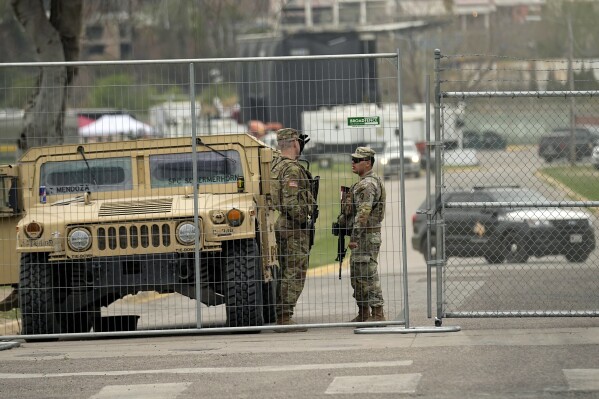 Members of the National Guard stand at a gate to Shelby Park along the Rio Grande, Wednesday, Feb. 28, 2024, in Eagle Pass, Texas. Republican presidential candidate former President Donald Trump is scheduled to visit the area Thursday. (AP Photo/Eric Gay)