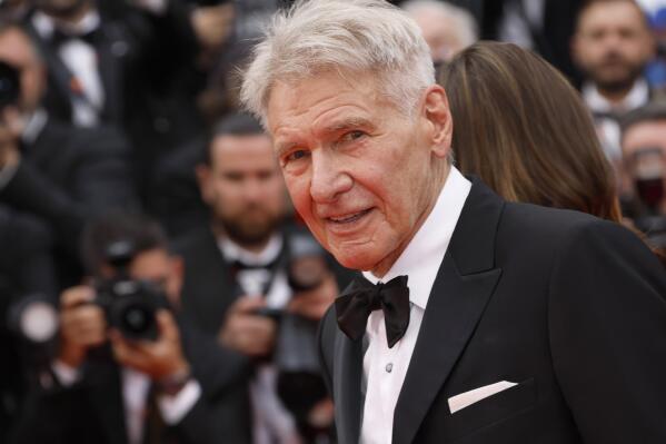 Harrison Ford poses for photographers upon arrival at the premiere of the film 'Indiana Jones and the Dial of Destiny' at the 76th international film festival, Cannes, southern France, Thursday, May 18, 2023. (Photo by Joel C Ryan/Invision/AP)