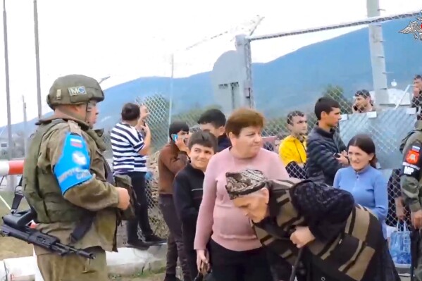 En esta imagen, tomada de un video distribuido por el Ministerio de Defensa de Rusia el 21 de septiembre de 2023, soldados de una misión de paz rusa protegen una cerca en un campamento cerca de Stepanakert, en Nagorno Karabaj. (Oficina de prensa del Ministerio de Defensa de Rusia vía AP)