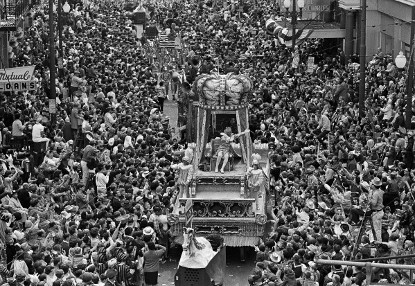 The float carrying Rex, King of Carnival, squeezes through a massive crowd in New Orleans during the parade which highlights Mardi Gras season, Feb. 22, 1966. About 1 million of Rex's fans were reported on hand to wave at the passing monarch during a Mardi Gras that came only six months after Hurricane Betsy flooded much of New Orleans. (AP Photo/Jack Thornell, file)