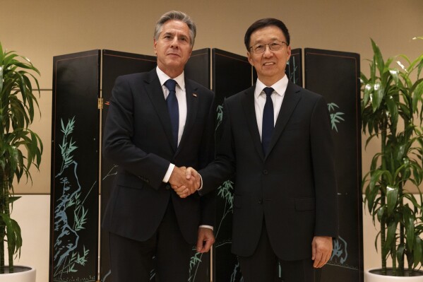 Secretary of State Antony Blinken and Chinese Vice President Han Zheng shake hands while posing for photos, Monday, Sept. 18, 2023, in New York. (AP Photo/Julia Nikhinson, Pool)