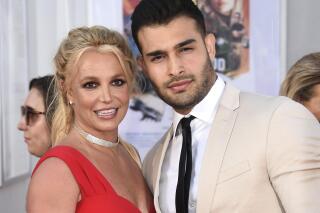 FILE - Britney Spears and Sam Asghari appear at the Los Angeles premiere of "Once Upon a Time in Hollywood" on July 22, 2019. Spears has married her longtime partner Sam Asghari at a Southern California ceremony that came months after the pop superstar won her freedom from a court conservatorship. Asghari’s representative Brandon Cohen confirmed the couple’s nuptials. (Photo by Jordan Strauss/Invision/AP, File)