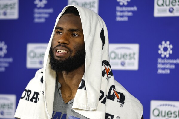 New York Giants linebacker Brian Burns talks to reporters after NFL football practice in East Rutherford, N.J., Thursday, June 5, 2025. (AP Photo/Noah K. Murray)