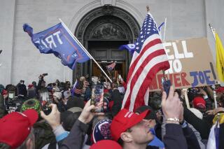 Rioters try to enter the U.S. Capitol on Jan. 6, 2021, in Washington. (AP Photo/John Minchillo)