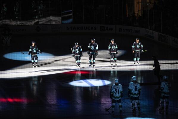 The Seattle Kraken take the ice for the first time against the Vancouver Cannucks in an NHL preseason hockey game Sunday, Sept. 26, 2021, in Spokane, Wash. Dean Rutz/The Seattle Times via AP)