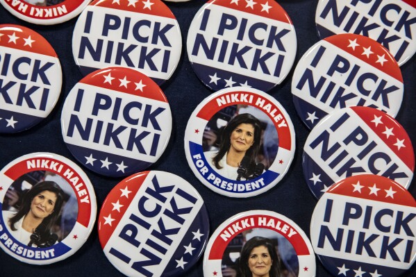Campaign buttons for Republican presidential candidate former U.N. Ambassador Nikki Haley sit on a table during a campaign event at the Lawrence Community Center in Anamosa, Iowa, on Thursday, Dec. 21, 2023. (Nick Rohlman/The Gazette via AP)
