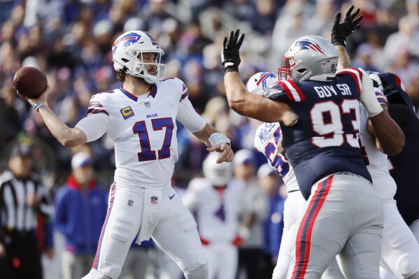 Buffalo Bills quarterback Josh Allen throws as New England Patriots defensive end Lawrence Guy Sr. (93) tries to block the pass during the first half of an NFL football game, Sunday, Oct. 22, 2023, in Foxborough, Mass. (AP Photo/Michael Dwyer)