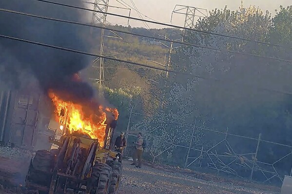 FILE - This image provided by the Atlanta Police Department shows construction equipment set on fire Saturday, March 4, 2023 by a group protesting the planned public safety training center, according to police. The trial was delayed Wednesday, Jan. 10, 2024, for the first defendant among dozens indicted last summer under Georgia's anti-racketeering law on allegations related to protests against a planned police and firefighter training facility near Atlanta. (Atlanta Police Department via AP, File)