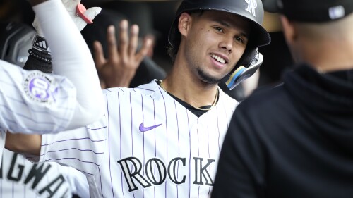Colorado Rockies' Ezequiel Tovar is congratulated as he returns to the dugout after a three-run home run against the Detroit Tigers during the sixth inning of a baseball game Friday, June 30, 2023, in Denver. (AP Photo/David Zalubowski)