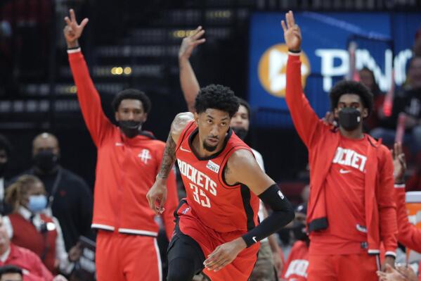 The Houston Rockets bench signals three after the three-point basket by center Christian Wood (35) during the first half of an NBA basketball game against the Oklahoma City Thunder, Friday, Oct. 22, 2021, in Houston. (AP Photo/Michael Wyke)