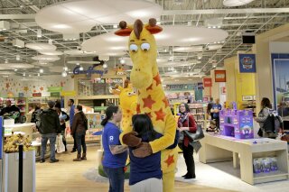 FILE - In this Dec. 9, 2019, file photo a girl hugs the Toys R Us mascot, Geoffrey, at the new store at a mall in Paramus, N.J  The only two Toys R Us stores that opened in November 2019 as part of a small U.S. comeback attempt by the iconic toy chain have now closed. The Toys R Us store at the Galleria mall in Houston shuttered on Jan. 15, while one at the Garden State Plaza in Paramus, New Jersey, closed on Tuesday, Jan. 26, 2021 according Tru Kids, a new entity formed when it acquired Toys R Us’ intellectual property during its liquidation in 2018.  (AP Photo/Seth Wenig)