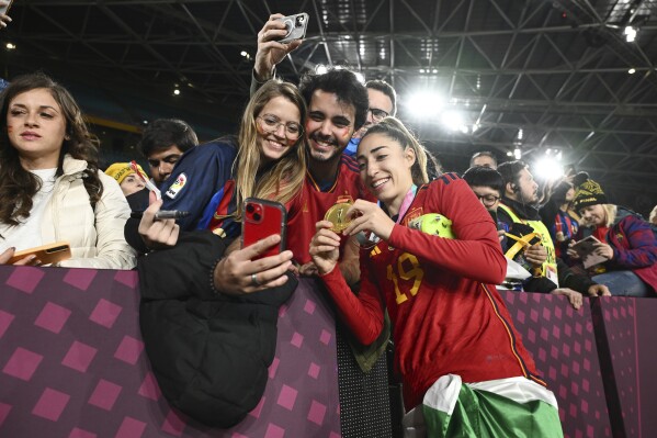 Spain's Olga Carmona celebrates with fans after the final of Women's World Cup soccer between Spain and England at Stadium Australia in Sydney, Australia, Sunday, Aug. 20, 2023. (AP Photo/Steve Markham)