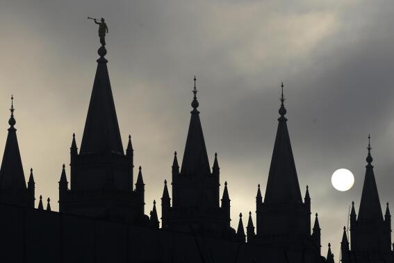 FILE - The angel Moroni statue atop the Salt Lake Temple is silhouetted against a cloud-covered sky, at Temple Square in Salt Lake City on Feb. 6, 2013. The U.S. Securities and Exchange Commission says, Tuesday, Feb. 21, 2023, The Church of Jesus Christ of Latter-day Saints and its investment arm will pay $5 million in fines. The SEC alleges the church used shell companies to obscure the size of the portfolio under the church's control.(AP Photo/Rick Bowmer, File)