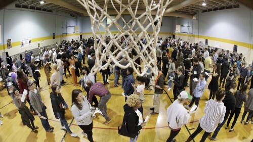 FILE - People wait to vote on Super Tuesday in the gymnasium at Cleveland Park Community Center, Tuesday, March 3, 2020, in Nashville, Tenn. While most GOP presidential candidates are focused only on early states like Iowa and New Hampshire, Donald Trump and Ron DeSantis also are looking ahead to Super Tuesday. March 5, 2024 is when the largest number of of delegates are up for grabs of any single day in the primary cycle. (AP Photo/Mark Humphrey, File)