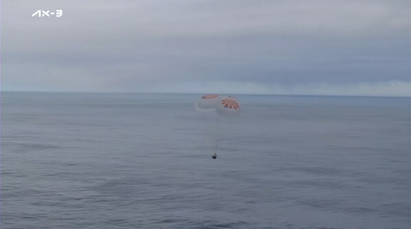 This photo provided by Axiom Space shows a SpaceX capsule parachuting into the Atlantic Ocean on Friday, Feb. 9, 2024 off the Florida coast. Astronauts from Turkey, Italy and Sweden returned to Earth on Friday, ending a private three-week mission to the International Space Station. (Axiom Space via AP)