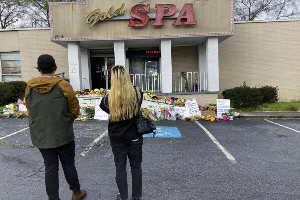 People view a makeshift memorial on Friday, March 19, 2021, in Atlanta.  Robert Aaron Long, a white man, is accused of killing several people, most of whom were of Asian descent, at massage parlors in the Atlanta area. (AP Photo/Candice Choi)