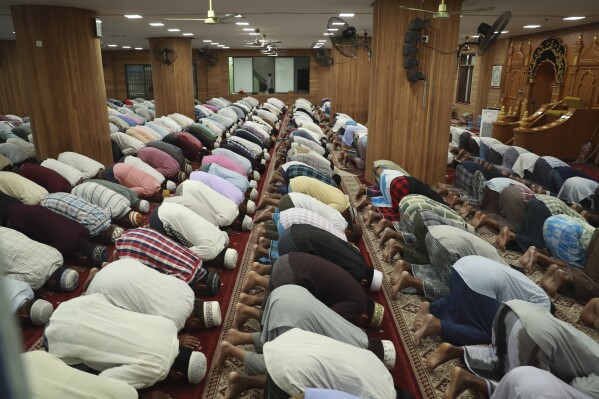 Myanmar Muslim men join evening prayer before their fast-breaking during the first day of Muslim's holy fasting month of Ramadan at Nwe Aye Mosque in Yangon, Myanmar, Tuesday, March 12, 2024. (AP Photo/Thein Zaw)