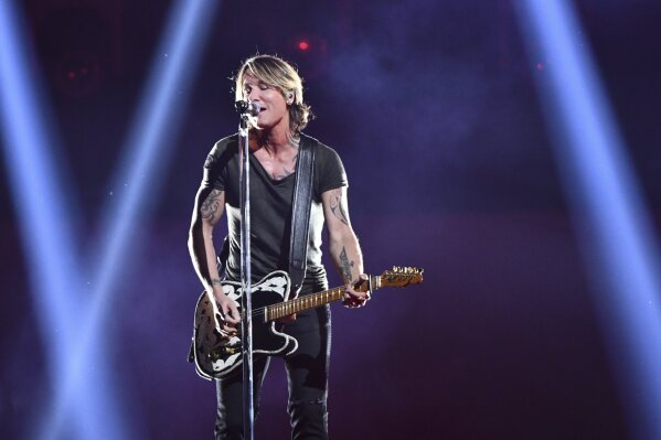 
              Keith Urban performs "Never Comin' Down" at the 52nd annual CMA Awards at Bridgestone Arena on Wednesday, Nov. 14, 2018, in Nashville, Tenn. (Photo by Charles Sykes/Invision/AP)
            