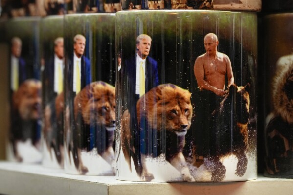 Cups with images of Russian President Vladimir Putin and U.S. President Donald Trump are displayed for sale at a souvenir shop in St. Petersburg, Russia, Thursday, Feb. 13, 2025. (AP Photo/Dmitri Lovetsky)