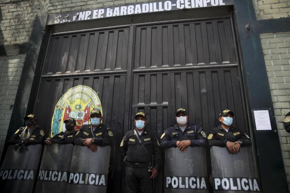 Police guard the jail where former Peruvian President Alberto Fujimori is being held in Lima, Peru, Tuesday, March 29, 2022. Earlier in the month, Peru's Constitutional Court approved Fujimori's release from prison where he is serving a 25-year sentence for murder and corruption charges, restoring a humanitarian pardon granted to Fujimori on Christmas Eve in 2017. (AP Photo/Guadalupe Pardo)