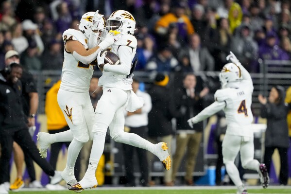 Arizona State defensive back Shamari Simmons (7) celebrates recovering a fumble by Washington quarterback Michael Penix Jr. with teammate Tate Romney, left, during the first half of an NCAA college football game Saturday, Oct. 21, 2023, in Seattle. (AP Photo/Lindsey Wasson)