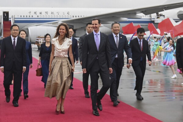 FILE - In this photo released by Xinhua News Agency, Syrian President Bashar Assad, center right, and first lady Asma Assad arrive in Hangzhou, China, on Sept. 21, 2023. China and Syria announced the formation of a strategic partnership on Friday, Sept. 22, 2023, as Chinese leader Xi Jinping kicked off a series of diplomatic meetings ahead of the upcoming Asian Games. (Huang Zongzhi/Xinhua via AP, File)